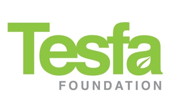 The Tesla Foundation logo features the word "Tesla" in large, green letters with a stylized leaf inside the letter "a," and "FOUNDATION" in smaller gray uppercase letters below.