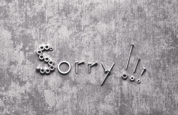 The word "Sorry!!" is creatively spelled out with various metal nuts and bolts on a gray textured background.