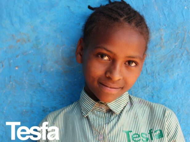 Tesfa Student Smiling in Uniform
