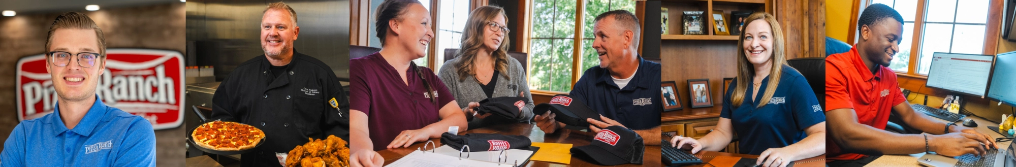 Group of people in a meeting, with staff wearing Pizza Ranch uniforms, sitting and working at a table with hats and documents, in a well-lit room with wooden walls.